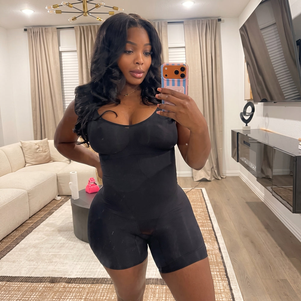 Black shorts bodysuit shown in a mirror selfie