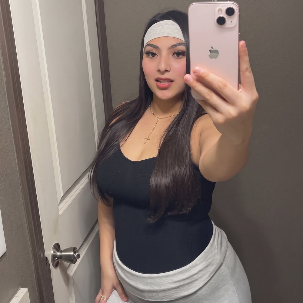 Black bodysuit styled with a light grey skirt